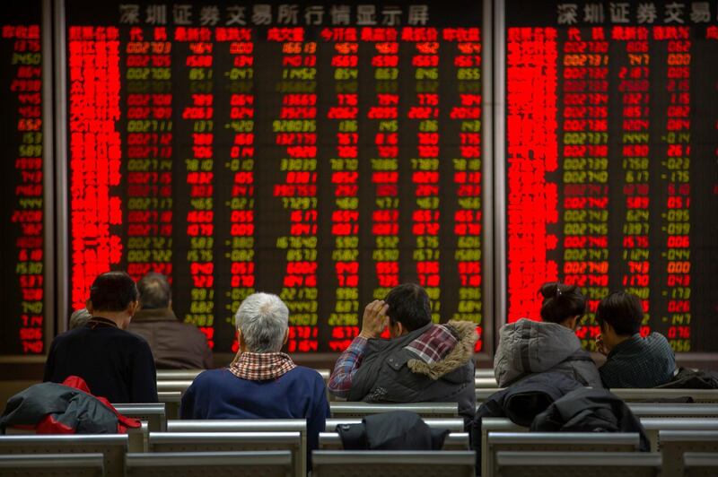 Chinese investors monitor stock prices at a brokerage house in Bejiing, Thursday, Dec. 26, 2019. Shares are mostly higher in Asia with many world markets closed for Christmas holidays. (AP Photo/Mark Schiefelbein)