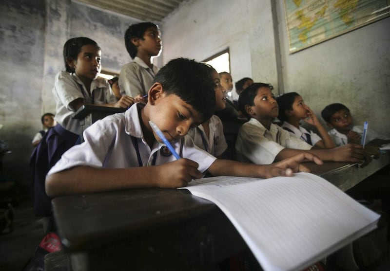 Students attend class at a school in Kolkata on Thursday, April 1, 2010, the day a law making primary education compulsory came into effect. Sucheta Das / AP Photo