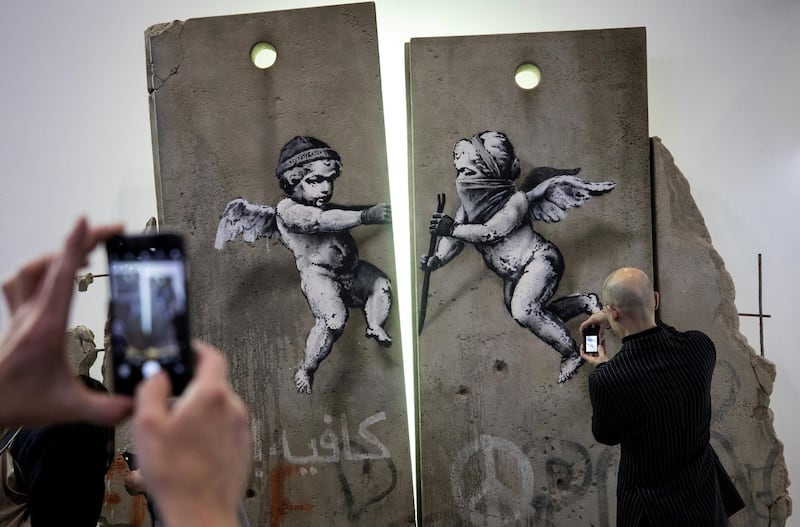 Visitors take photographs of the 'replica separation barrier'. Reuters