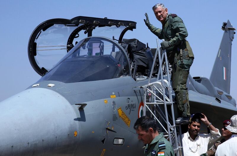epa07385447 Chief of The Indian Army Bipin Rawat gestures before he sits inside the cockpit of Indian Air Force (IAF) Tejas fighter jet during the second day of the 12th edition of the Aero India 2019 at the Yelahanka Air Force Station in Bangalore, India, 21 February 2019.  Over 350 defense and aerospace firms from 30 countries are taking part in the event running from 20 to 24 February.  EPA/JAGADEESH NV
