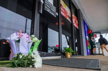 Flowers left by well-wishers sit at the entrance to Young’s Asian Massage in Acworth, Georgia. EPA
