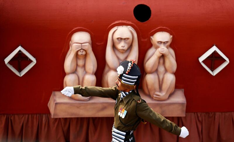 A soldier marches beside a tableau during the Republic Day parade in New Delhi. Adnan Abidi / Reuters