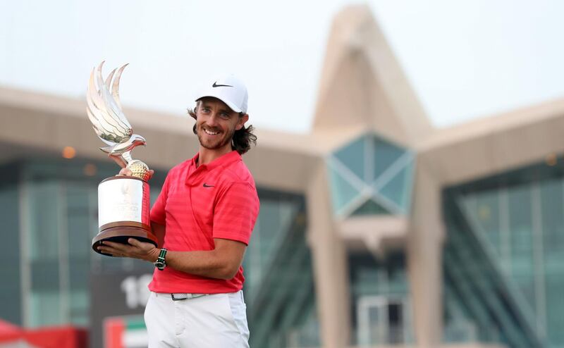 Tommy Fleetwood of England poses with the winner's trophy while celebrating his victory at the Abu Dhabi HSBC Golf Championship, at the Abu Dhabi Golf Club on January 21, 2018.
Fleetwood successfully defended his title at the $3 million Abu Dhabi Championship, shooting a seven-under par 65 round to beat compatriot Ross Fisher by two shots. / AFP PHOTO / KARIM SAHIB