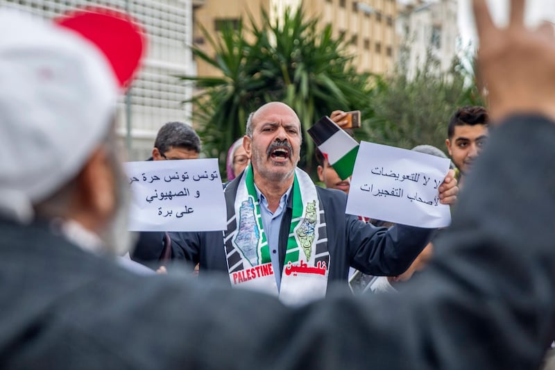 A man holds anti-Israel posters outside the Tunisian Tourism Ministry in Tunis.  Rene Trabelsi, a Jew, has been recently named Tunisian tourism minister, a first in more than 50 years. AP