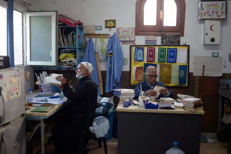 Libyan volunteers repair copies of the Quran during Ramadan in Tripoli. Reuters