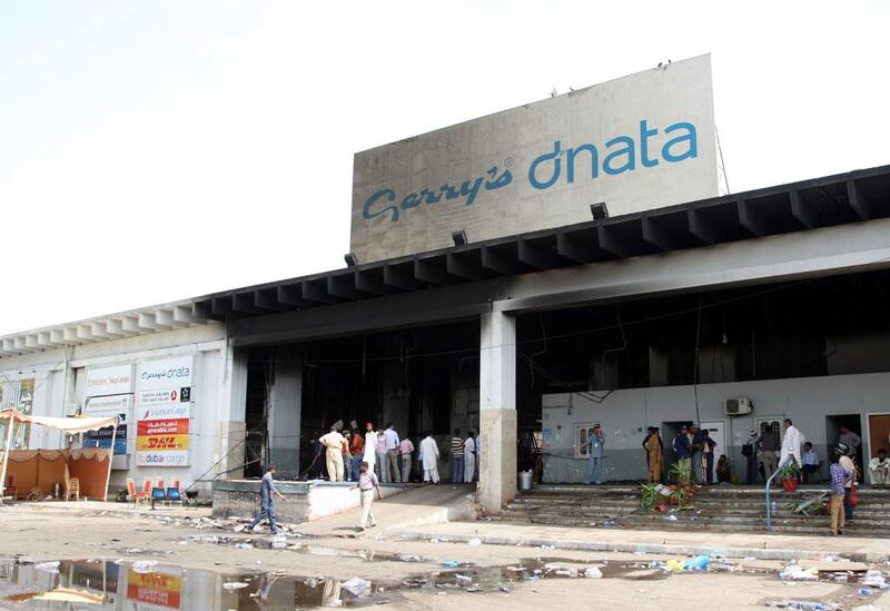 Pakistani security officials at the fire-damaged building of a cold-storage cargo facility where bodies of airport workers were discovered a day after the assault, ‘charred beyond recognition’.  Rehan Khan/EPA