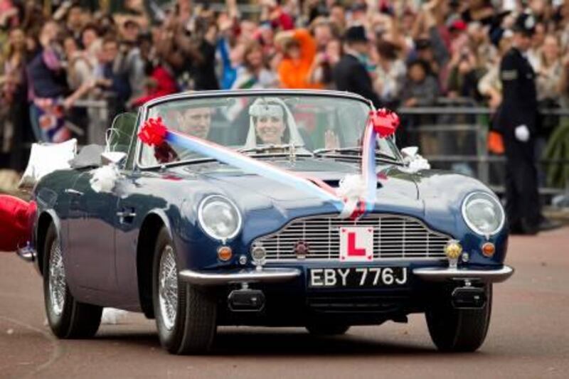 Britain's Prince William drives his wife, Kate, Duchess of Cambridge on The Mall in London in his father Prince Charles' Aston Martin Volante sports car covered with bunting on their way to Clarence House after their wedding in nearby Westminster Abbey, in London Friday April 29, 2011. (AP Photo/Daniel Ochoa de Olza) *** Local Caption ***  DO113_Britain_Royal_Wedding.jpg