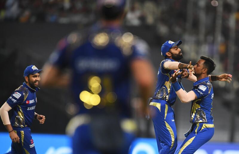 Mumbai Indians cricketer Krunal Pandya (R) celebrates with teammates the wicket of Kolkata Knight Riders cricketer Chris Lynn during the 2018 Indian Premier League (IPL) Twenty20 cricket match between Kolkata Knight Riders and Mumbai Indians at The Eden Gardens Cricket Stadium in Kolkata on May 9, 2018.   / AFP PHOTO / Dibyangshu SARKAR / ----IMAGE RESTRICTED TO EDITORIAL USE - STRICTLY NO COMMERCIAL USE----- / GETTYOUT