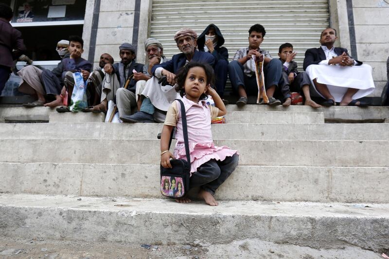 Conflict-ridden people wait to get their families' free food ration from a charity kitchen in Sana'a, Yemen.   EPA