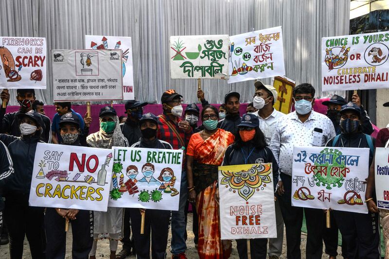 People hold placards to raise awareness on air pollution caused by firecrackers, in Siliguri. AFP