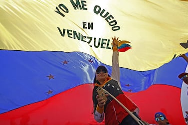 A woman holds a Venezuelan flag as she takes part in the "Venezuela Aid Live" concert. AFP