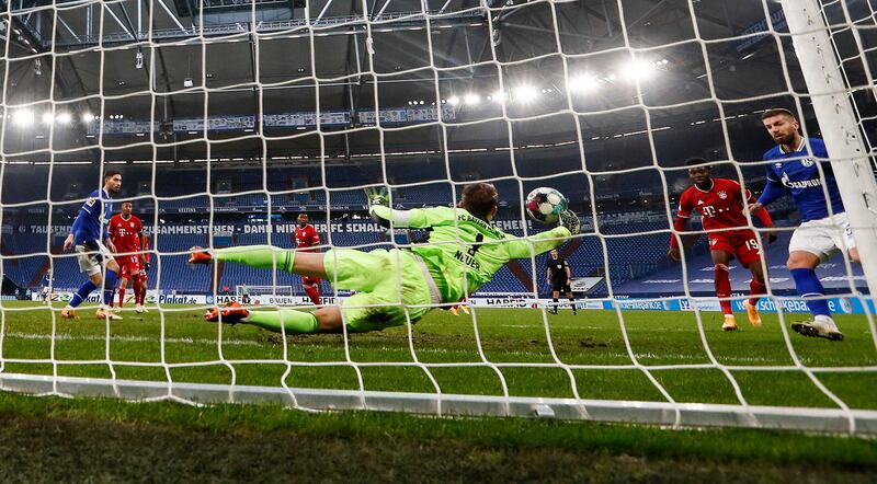 Bayern goalkeeper Manuel Neuer saves from Schalke's Mathew Hoppe. AP