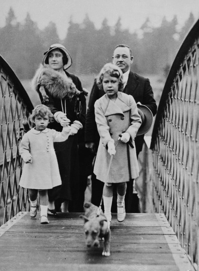 Princess Elizabeth, Princess Margaret and their mother Queen Elizabeth cross a railway bridge near the Scottish town of Forfar in 1933. Getty