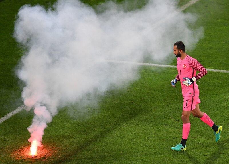 Goalkeeper Volkan Babacan of Turkey removes a flare during the UEFA EURO 2016 group D preliminary round match between Czech Republic and Turkey at Stade Bollaert-Delelis in Lens Agglomeration, France, 21 June 2016. EPA/FILIP SINGER
