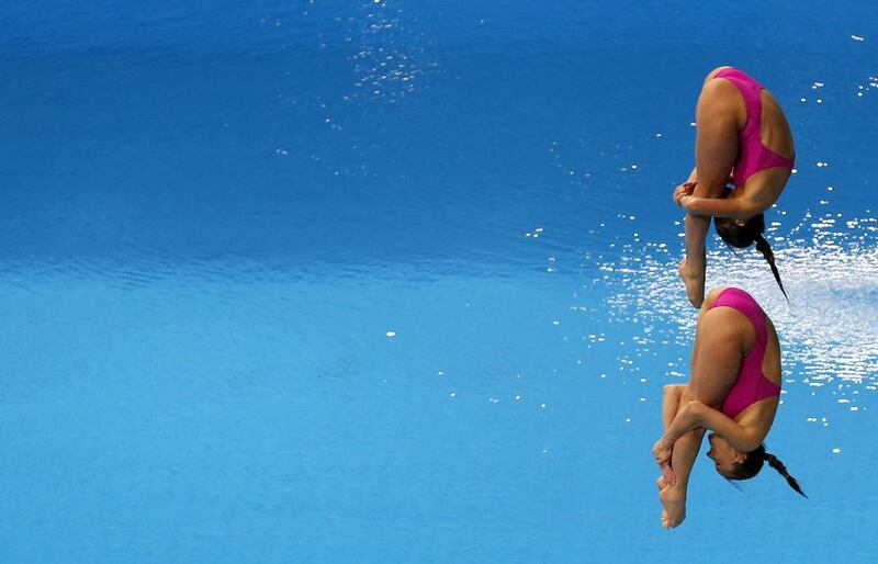 Tania Cagnotto and Francesca Dallape of Italy dive at the Fina Diving World Series 2014 at the Hamdan Sports Complex. Karim Sahib / AFP  