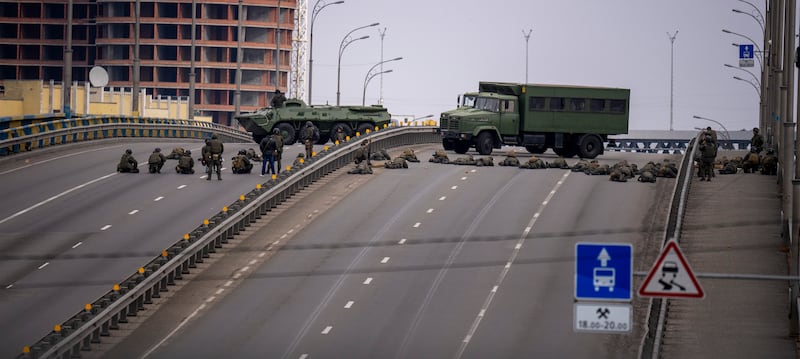 Ukrainian soldiers take position on a bridge in the city of Kiev, Ukraine. AP Photo