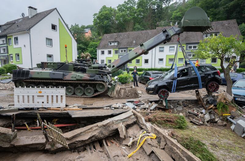 A damaged car is hoisted during the clean-up operation in Hagen, Germany..