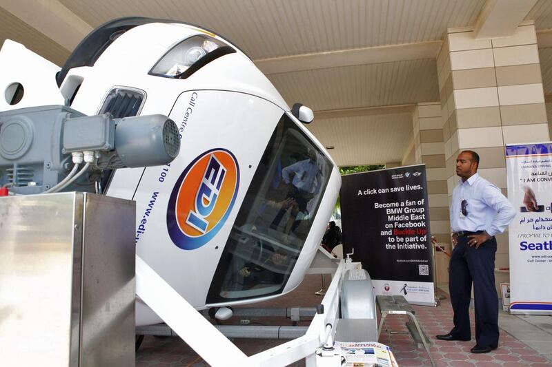 Despite public-service campaigns, including this car-roll simulator that demonstrates the value of seat belts, a reader notes that the UAE lags behind in attitudes towards road-safety measures. Antonie Robertson/The National