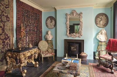 Hodkin's living room in Bloomsbury included wall hung 19th century Persian carpets, a 16th century Spanish statue of a saint, a brass 16/17th century brass pilgrim flask, from the Deccan, India, a bust of King George II (1683-1760) by the sculptor Michael Rysbrack, (c.1739), 18th century relief panels with Allegories, Britain, 18th century, a mirror from the manor of John Vardy (c.1740), a bust of King Louis XIV (c. 1700-15) and a 19th century Venetian armchair. Sotheby's