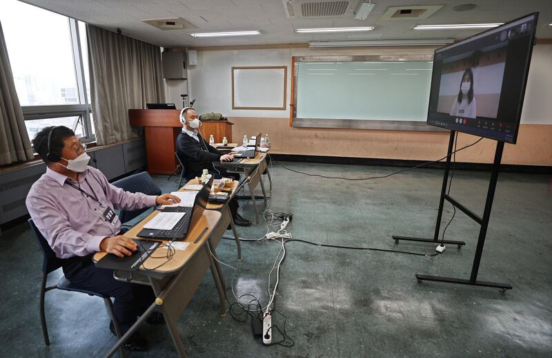 Interviewers conduct a video interview with a woman for college entrance exams amid in a classroom at Hankuk University of Foreign Studies in Seoul. AFP