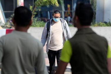 Some UAE residents, such as this man in Bur Dubai, are wearing face masks in the belief this will reduce the risk of catching coronavirus. Pawan Singh / The National
