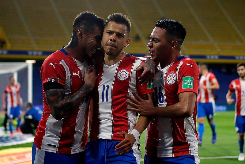 Paraguay's Angel Romero celebrates with teammates after scoring against Argentina. AFP