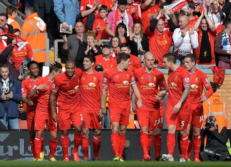 Liverpool FC players, after Luis Suarez scored the second goal on Sunday. The win put Liverpool on top of the Premier League table. Peter Powell / EPA / March 30, 2014