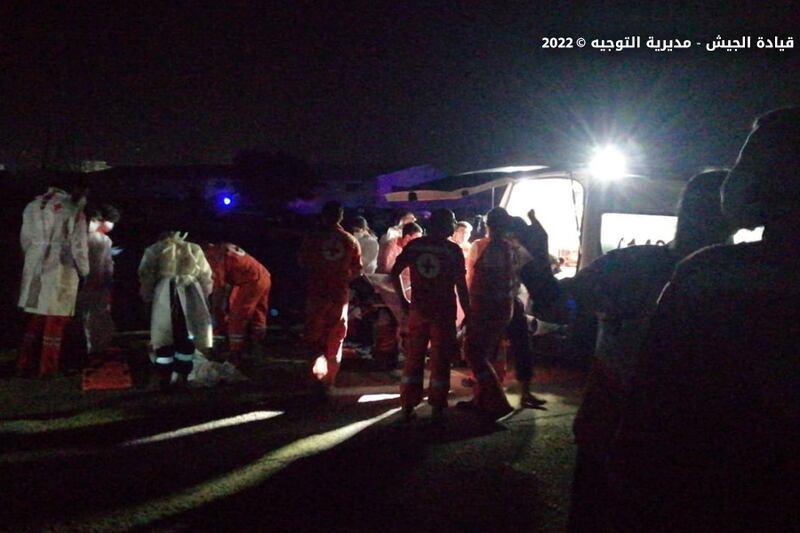 Red Cross forces giving first aid to people rescued off the Lebanese coast. EPA
