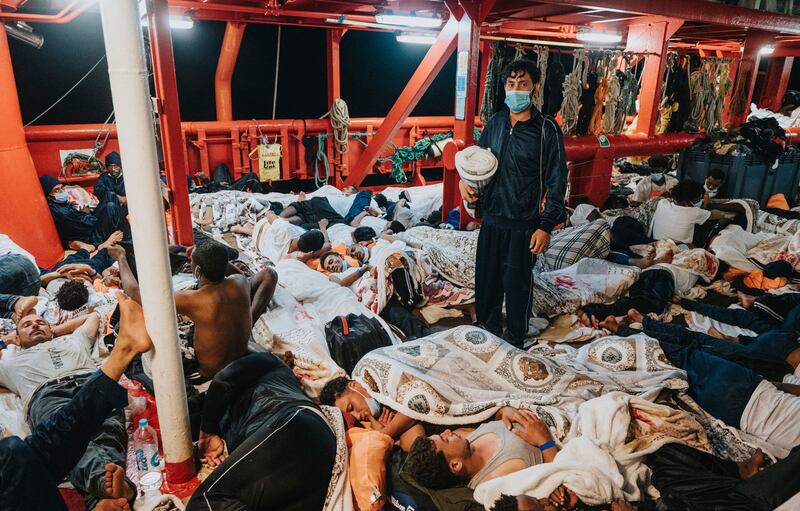 Migrants sleep on the deck of the 'Ocean Viking'. AP Photo