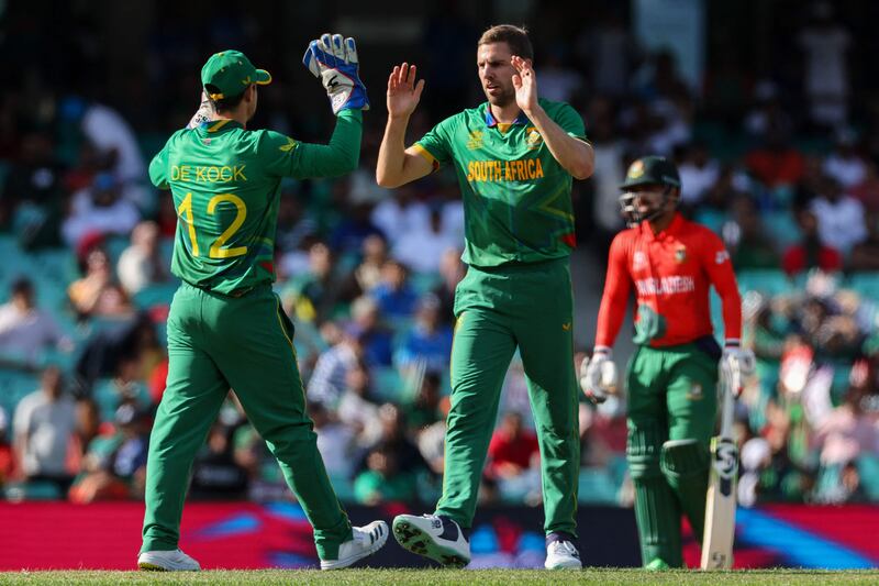 Anrich Nortje celebrates with Quinton de Kock after taking a wicket. AFP