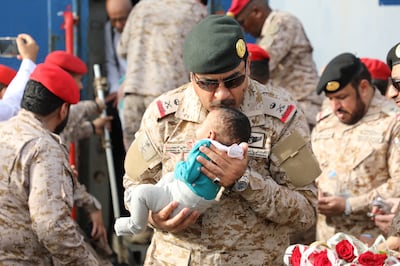 Saudi Navy personnel assist a child at Jeddah Sea Port. Photo: Saudi Ministry of Defence 
