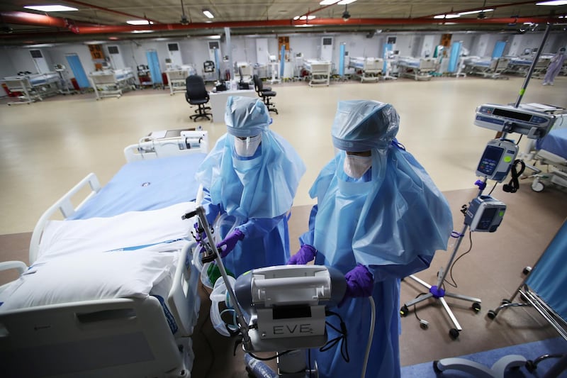 Nurses are seen doing their final check on the equipment in a makeshift ICU "Field Intensive Care Unit 1" set up by Bahrian authorities to treat the coronavirus disease (COVID-19) critical patients, at a car-park of Bahrain Defence Force Hospital in Riffa, Bahrain, April 14, 2020. REUTERS/Hamad I Mohammed