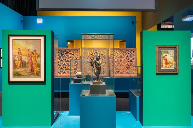 A 19th-century statuette of Krishna sits alongside works by Raja Ravi Varma at Louvre Abu Dhabi's Bollywood Superstars exhibition. Photo: Louvre Abu Dhabi
