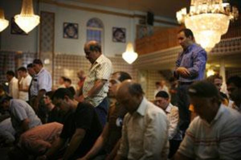 Men praying in the Fatih Mosque in New York. Some 80 per cent of US Muslims surveyed say religion plays an important part in their daily lives.