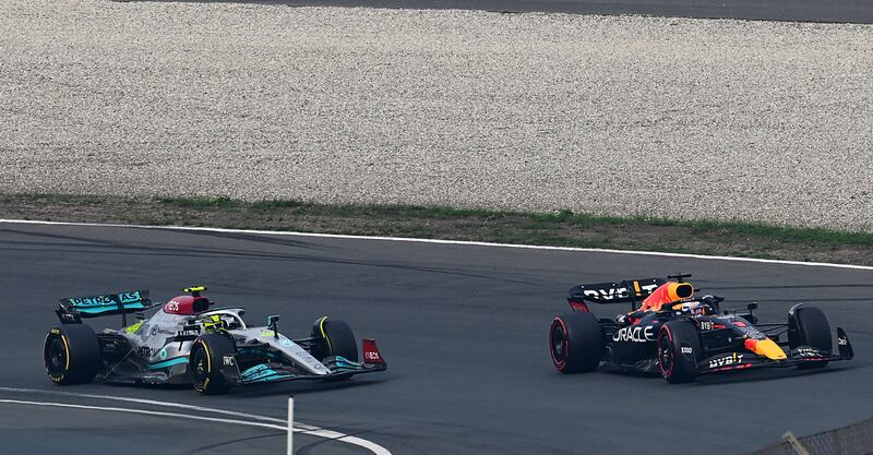 Max Verstappen's Red Bull overtakes the Mercedes of Lewis Hamilton after the safety car restart during the Dutch Grand Prix in Zandvoort. Getty