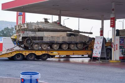 A lorrie carrying a tank stops at a gas station near the border between Israel and Lebanon. Willy Lowry / The National