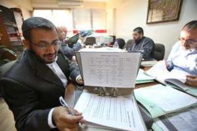 Badi Rafayaa (L), the head of the professional associations anti normalisation committee checks on some papers during a mechanical engineers' committee meeting in the Jordanian professional associations compound in Amman, Jordan on October 04, 2009. (Salah Malkawi for The National) *** Local Caption ***  SM001_Anti_Normalisation.jpg