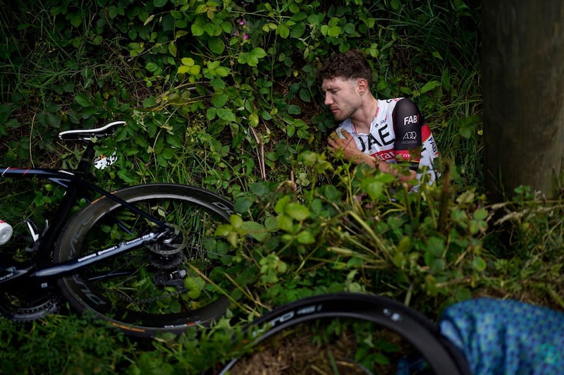 UAE Team Emirates rider Marc Hirschi lays on the side of the road after crashing during the first stage of the Tour de France.
