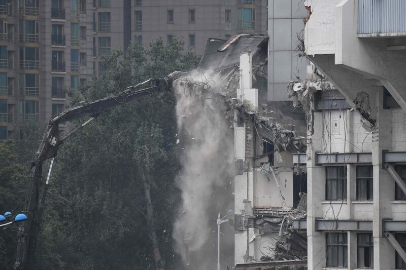 Workers demolish a seating area in the Workers' Stadium in Beijing. AFP