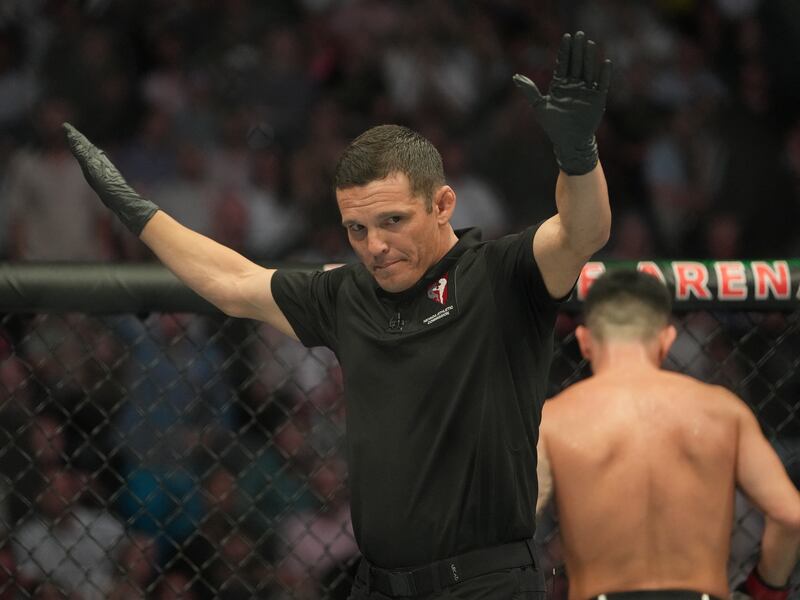 Referee Jason Herzog waves off the fight after Pedro Munhoz was accidentally poked in the eye. USA TODAY Sports