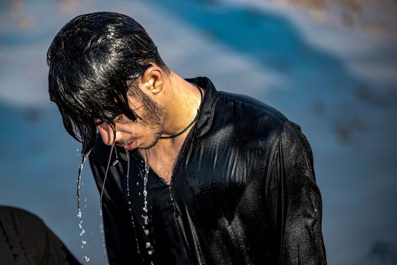 Water drips from the hair of a Shiite Muslim pilgrim after bathing in the Gulf waters at the start of his march from Iraq's southern city of Al Faw towards Karbala.