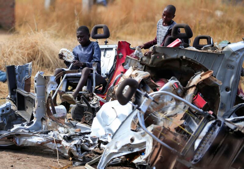 Children play at a scrap metal collection point in Hopley, a settlement about 15 kilometres west of Zimbabwe's capital, Harare. Reuters