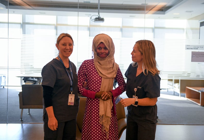 Nasriya Shure, centre, with staff at Sheikh Shakhbout Medical City in Abu Dhabi. Khushnum Bhandari / The National