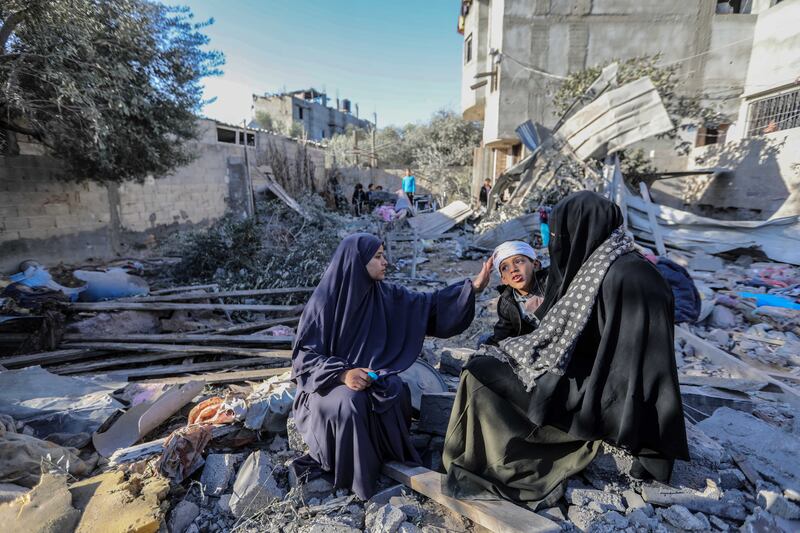 People inspect damage to their homes caused by Israeli air strikes on January 18 in Rafah, Gaza. Getty