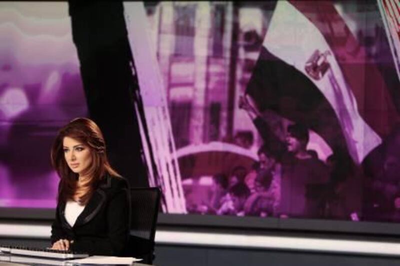 News anchor Rola Ibrahim is seen in the studio of the Arabic Al Jazeera satellite news channel in Doha in this February 7, 2011 file photo. Over the past few weeks, much has been made of the power of Al Jazeera, the Qatari news channel launched 15 years ago by the Gulf Arab state's Emir Sheikh Hamad bin Khalifa al-Thani with the goal of providing the sort of independent news that the region's state-run broadcasters had long ignored. It was Al Jazeera that first grasped the enormity of the Tunisia uprising and its implications for the region, and Al Jazeera which latched onto -- critics would say fuelled -- subsequent rumblings in Egypt. And audiences around the world responded: the network's global audience has rocketed. To match Special Report ALJAZEERA/       REUTERS/Fadi Al-Assaad/Files  (QATAR  - Tags: MEDIA BUSINESS) *** Local Caption ***  QAT09_ALJAZEERA-_0217_11.JPG