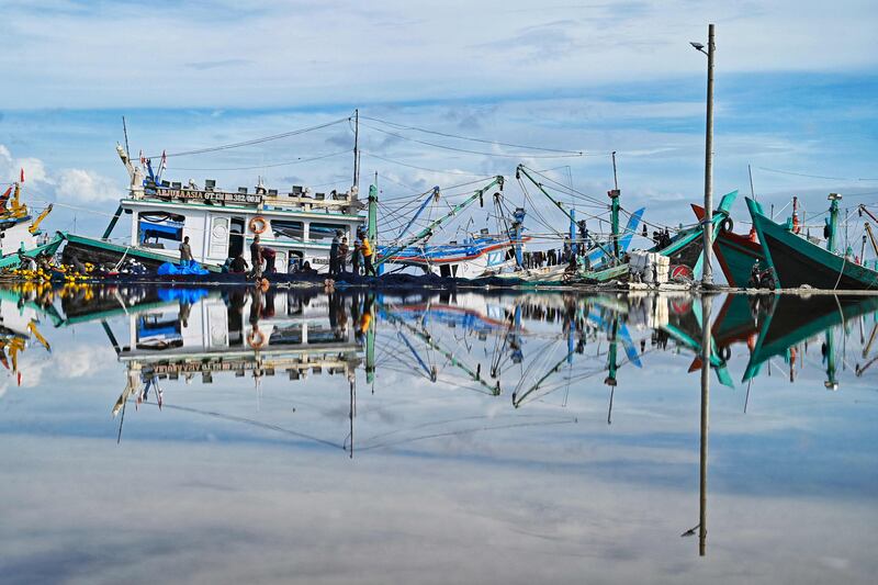 Fishermen check their nets during 'no fishing Friday' at a port in Banda Aceh, Indonesia. AFP