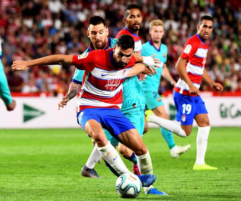 Granada midfielder Antonio Puertas in action against Barcelona forward Lionel Messi. EPA