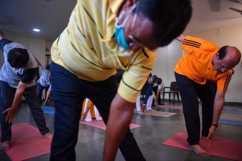 Men attend a yoga class in Mumbai. AFP