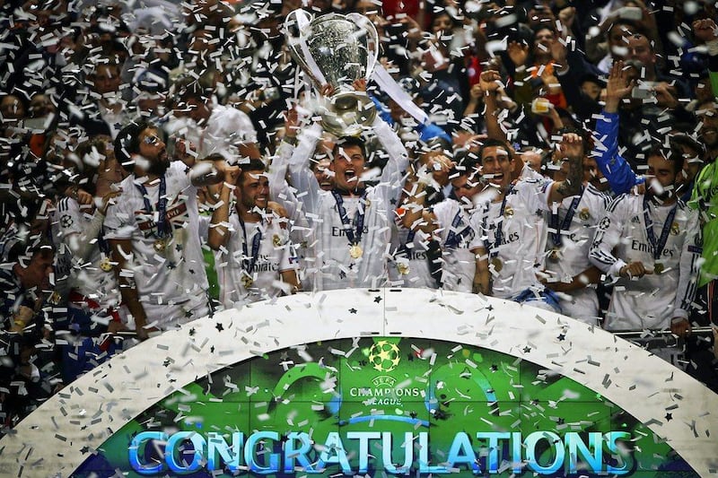 Real Madrid striker Cristiano Ronaldo and his teammates celebrate with the European Cup trophy after their Champions League final victory over Atletico Madrid on Saturday night. Mario Cruz / EPA / May 24, 2014