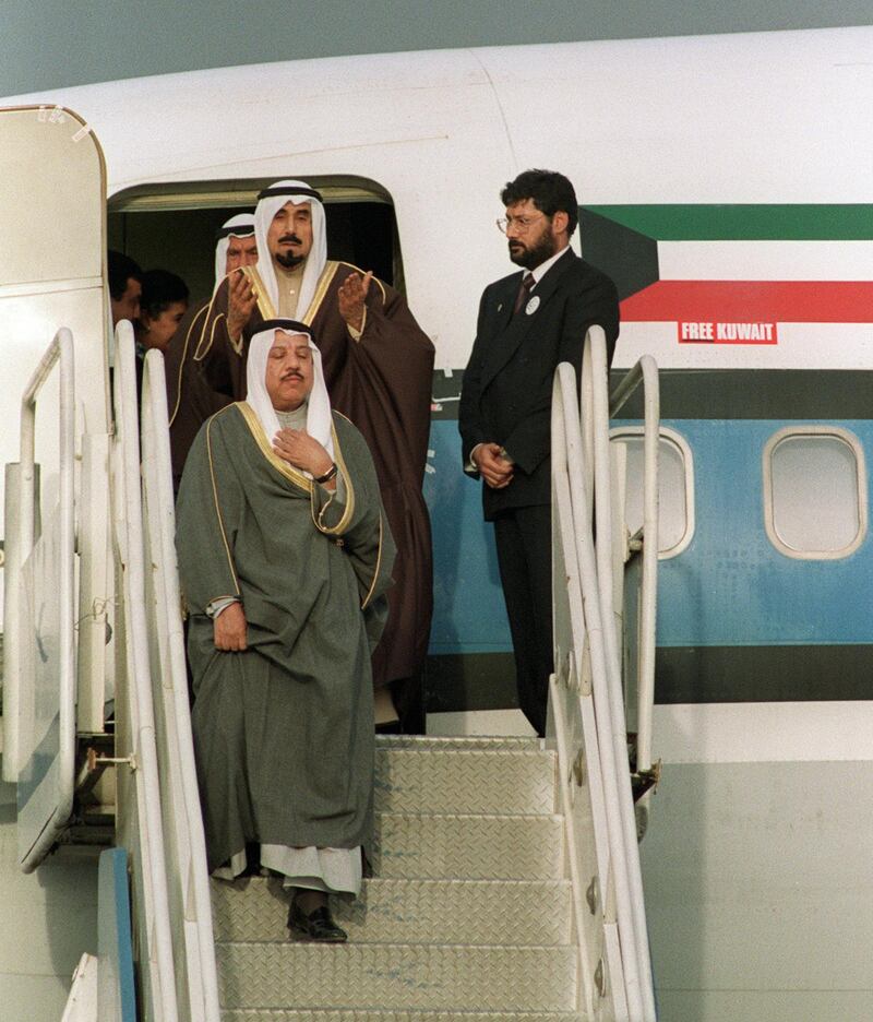 Sheikh Jaber al-Ahmad al-Sabah (top), Emir of Kuwait, prays as he disembark his plane 14 March 1991 upon his arrival at Kuwait International Airport after more than seven months in exile during the Iraqi occupation of his country. A US-led multinational coalition evicted Iraqi occupation forces in February 1991 at the end of the six-week conflict. Three years later, Iraq officially recognized the state of Kuwait and its UN-demarcated borders. MP Uday Saddam Hussein, the elder son of the Iraqi president, has renewed 15 January 2001 claims to Kuwait as forming part of a "Greater Iraq", in an except of a report to parliament in Baghdad. (Photo by BOB PEARSON / AFP)